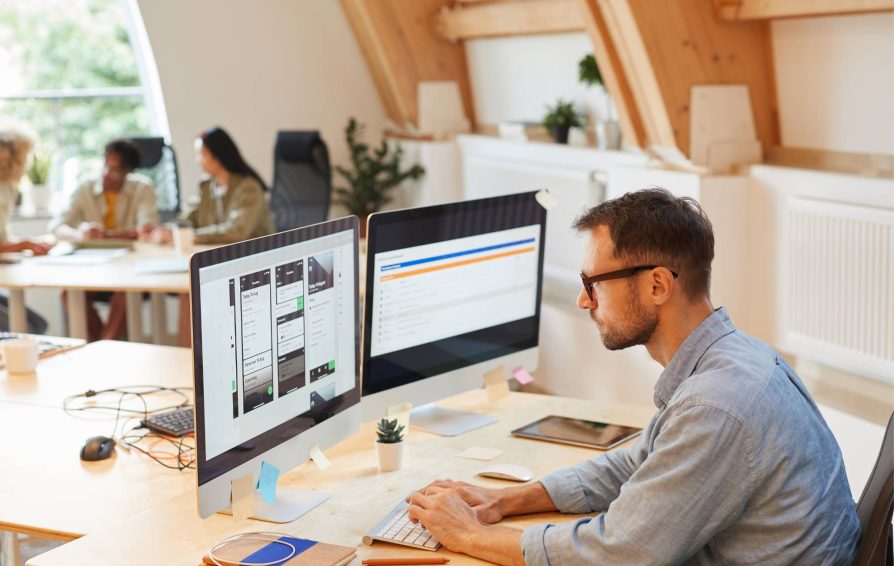 Man on desktop using business process automation tools