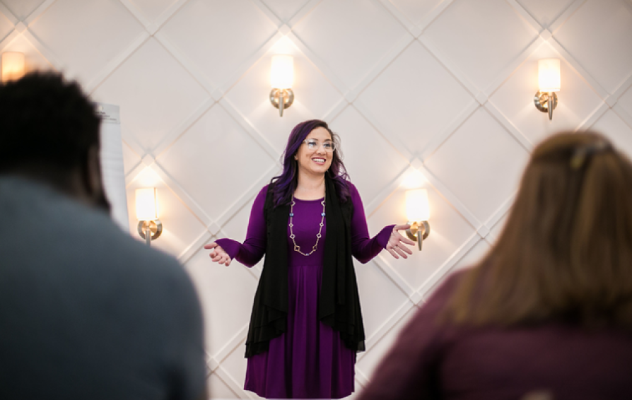 A woman gives a talk to an audience