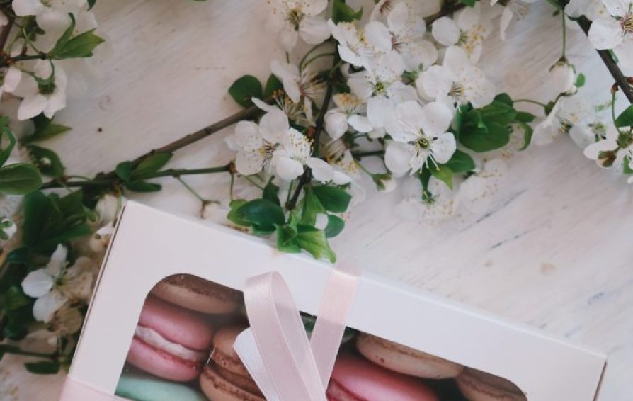 a table with macaroons and flowers