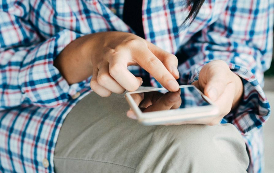 Person designing a brochure on a phone