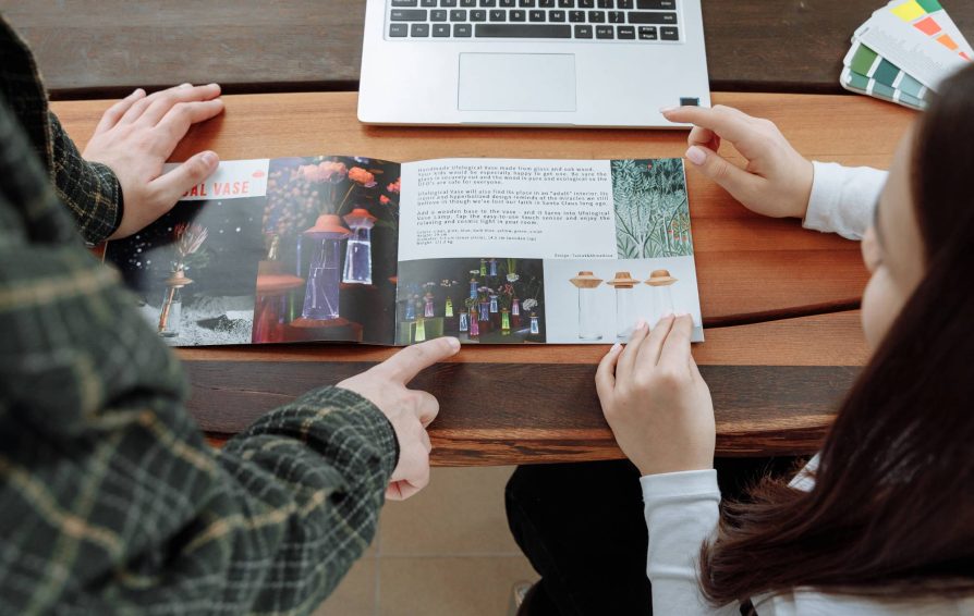 Two people looking at brochure examples together