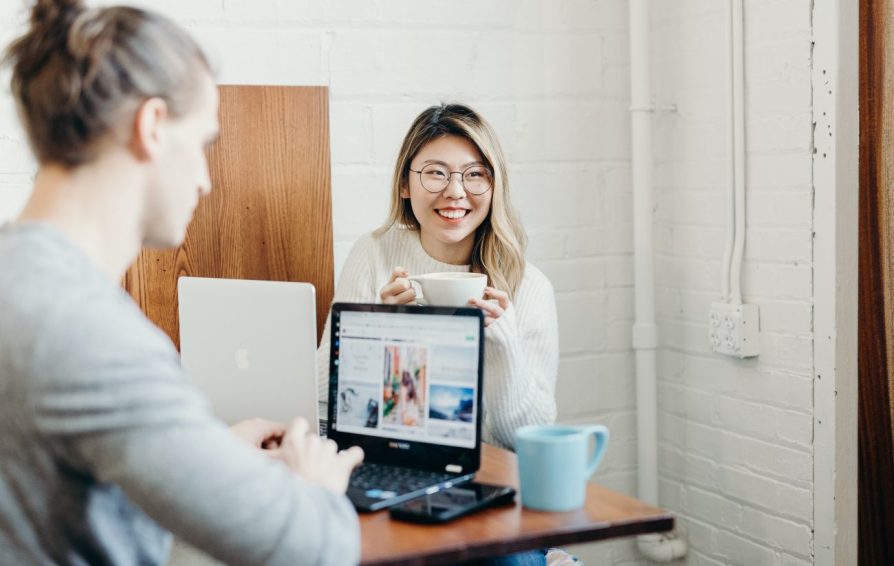 two people on laptops creating content for instagram