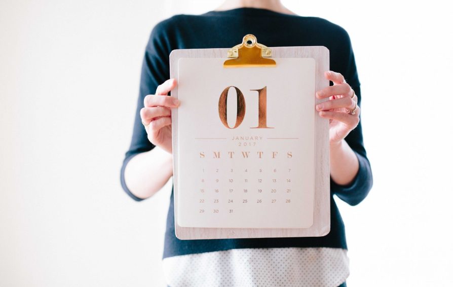 personal consulting a calendar in preparation for 2019