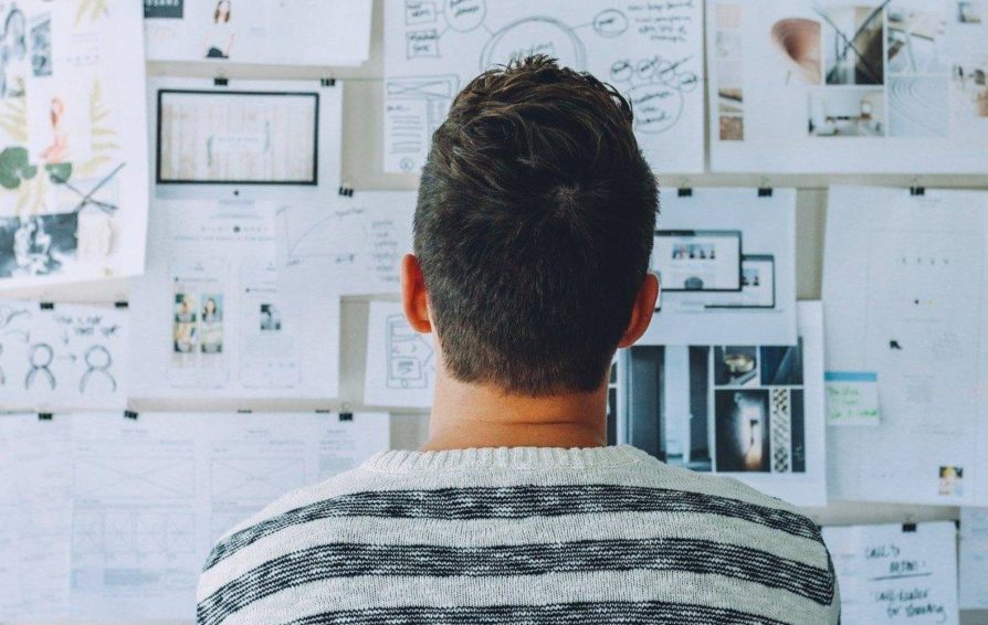 Man creating a business growth plan with a pin board