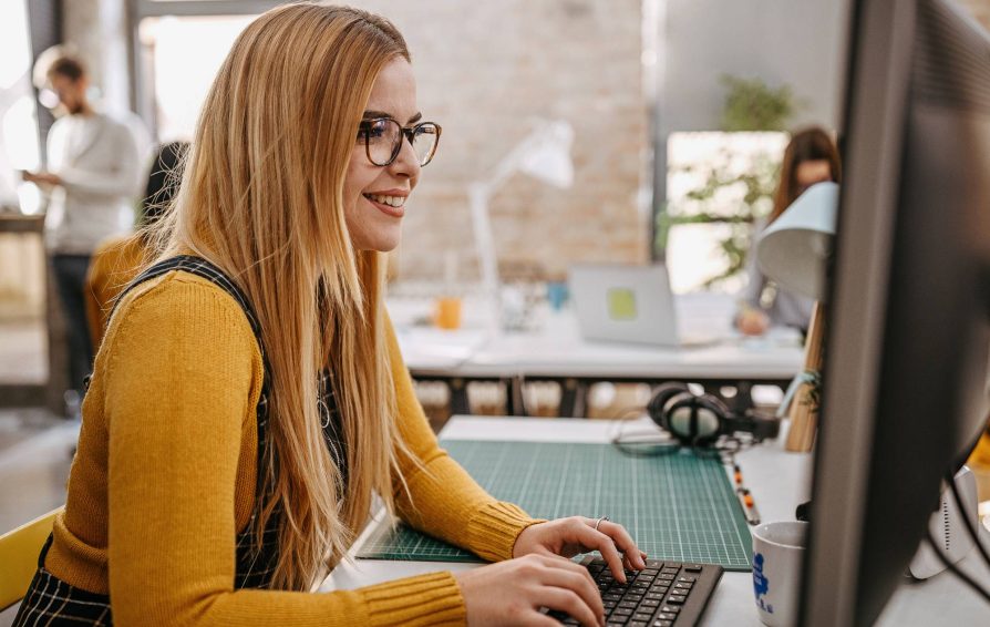 Woman using a business management system at her computer