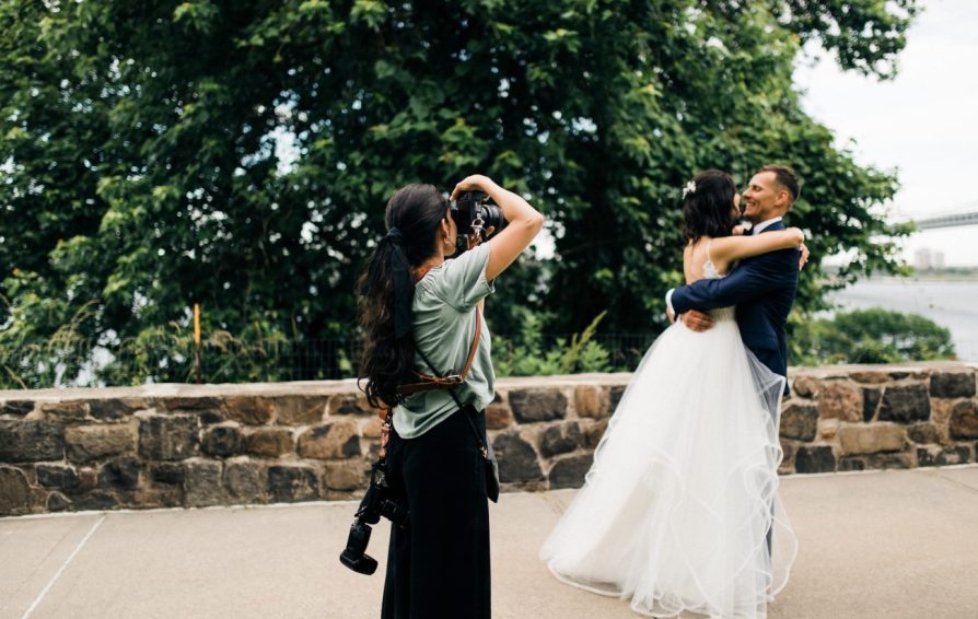 photographer taking pictures of a bride and groom