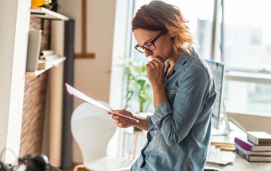 Woman reading through a client contract