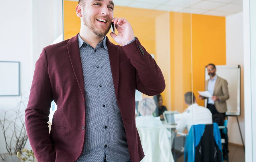 Man on the phone using his client management skills