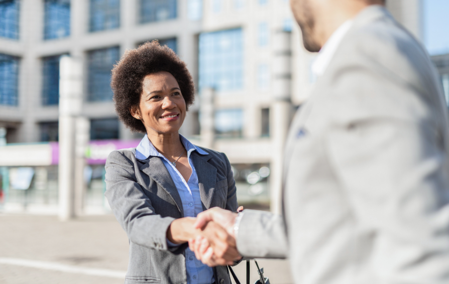 Woman meeting a client after a seamless client onboarding workflow