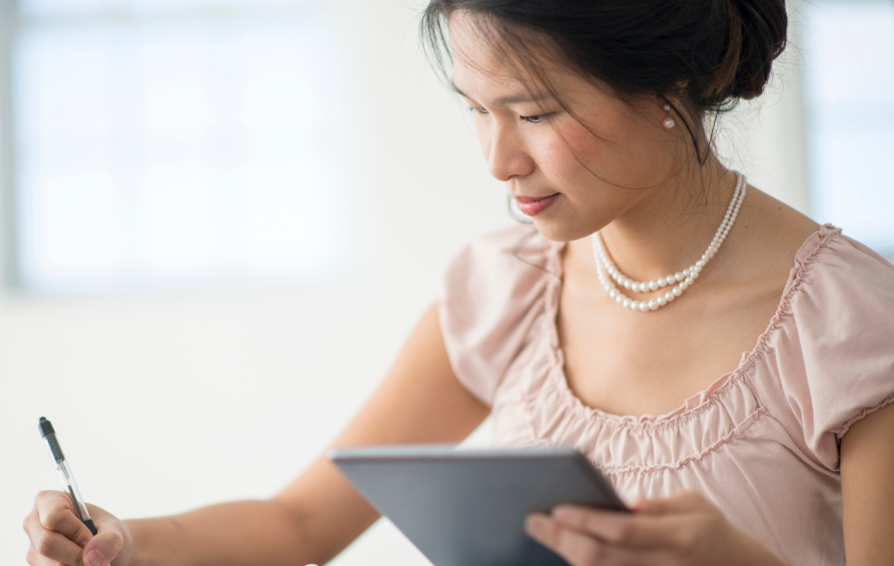Woman writing down questions to ask clients