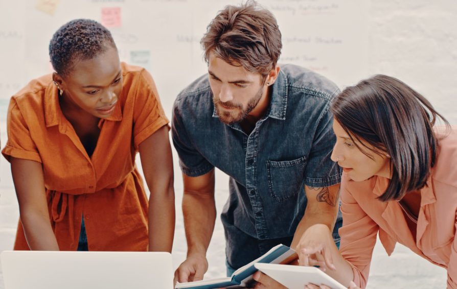 Three people meeting to discuss client onboarding