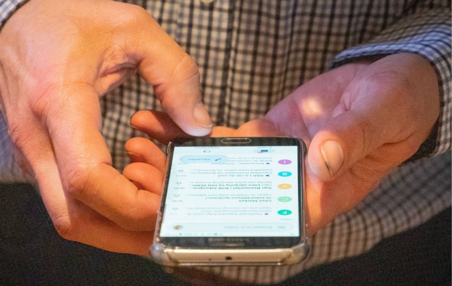 Person looking at confirmation email templates on their phone