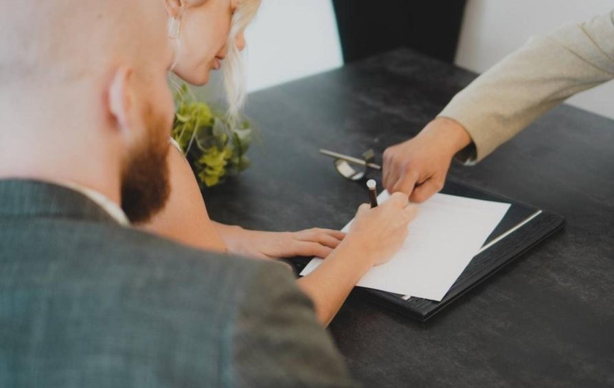 People signing a contract for service