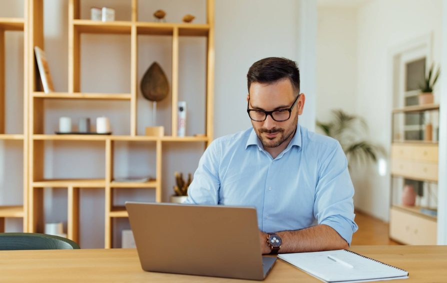 man answering pricing questions on his laptop