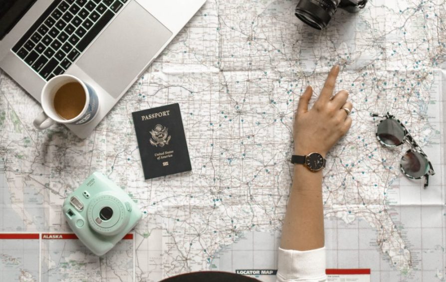 woman looking at a map learning how to manage her time while traveling
