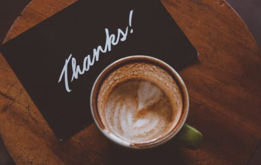 Aerial view of a latte and a card with 