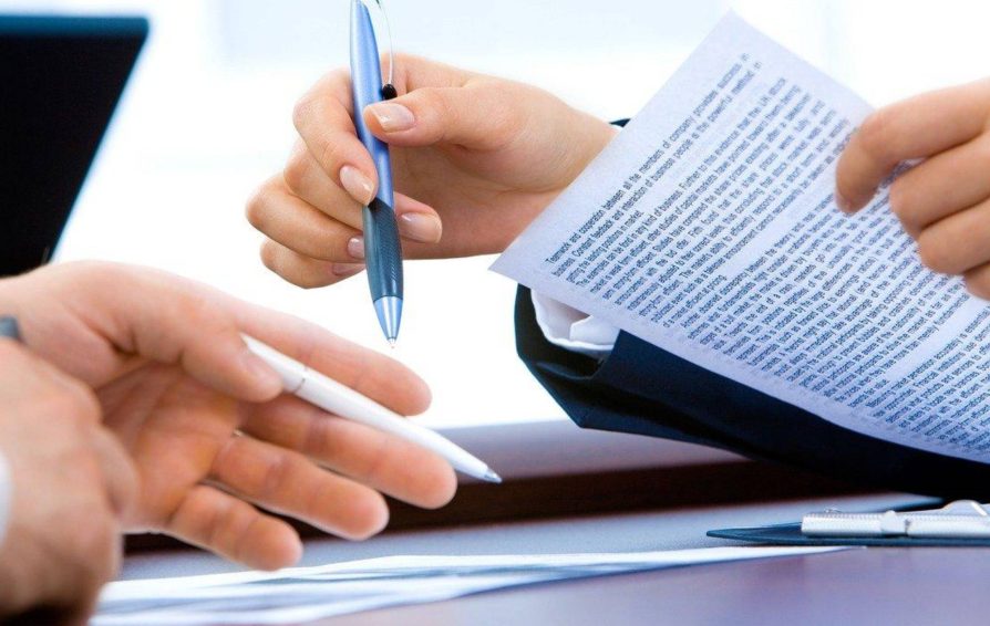 People signing an independent contractor agreement