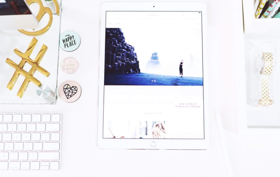 Top down view of an ipad laying on a desk.