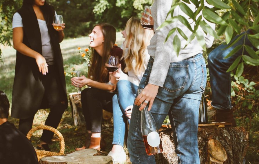 business mentor speaking with a group of people in a casual outdoor setting