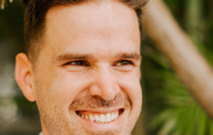 Close up of a man smiling.