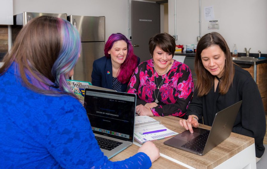 marketing team working on their pinterest strategy at a desk