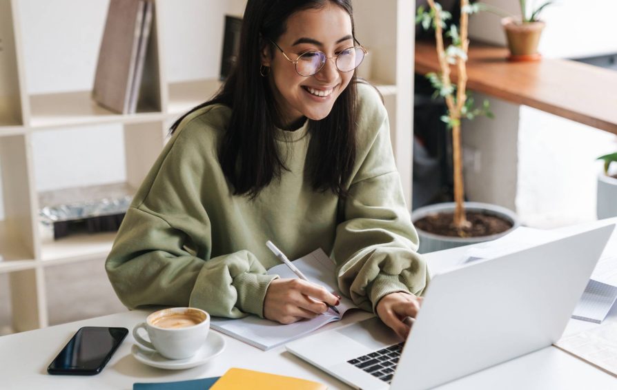 Woman creating a lead magnet on her laptop