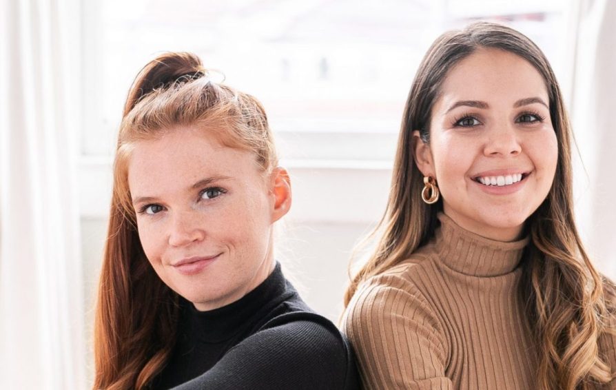 Close up of two women smiling at the camera.