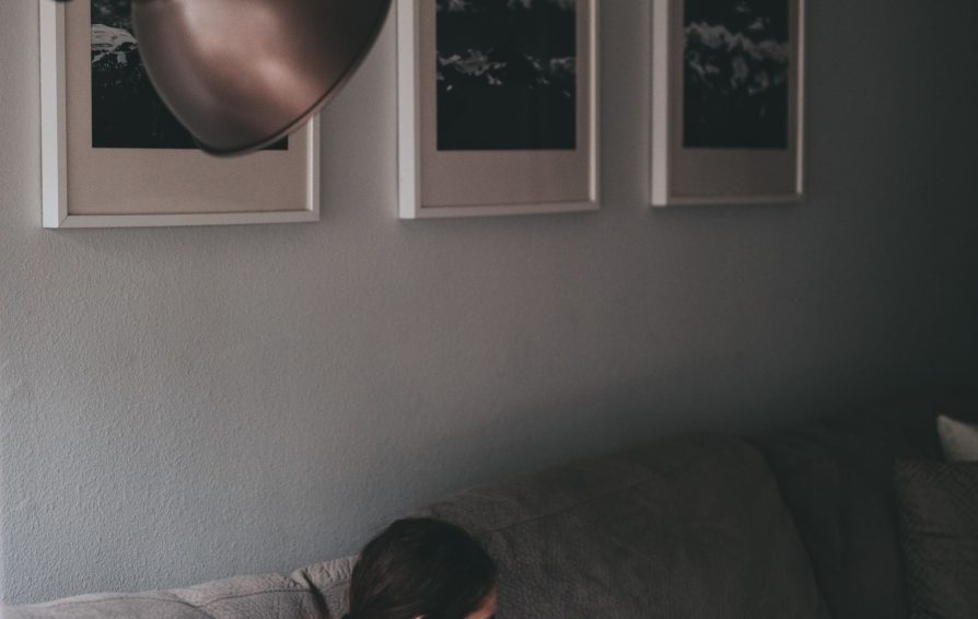 person reading and having coffee on the couch