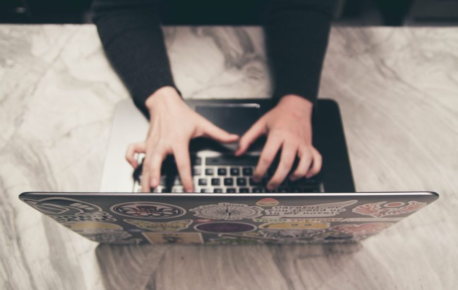 a woman typing on a laptop learning how to deal with email anxiety