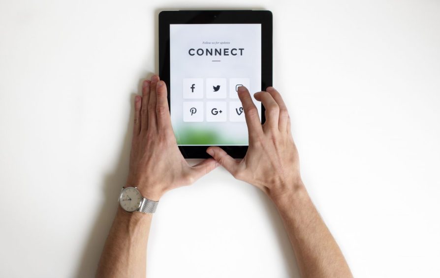 Top down view of man using an ipad that says 