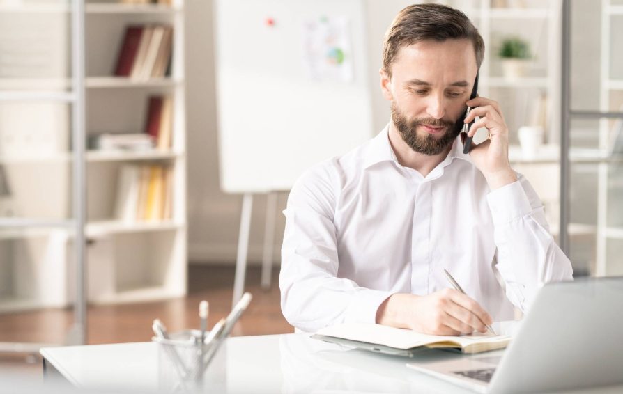 Man asking client onboarding questions on the phone