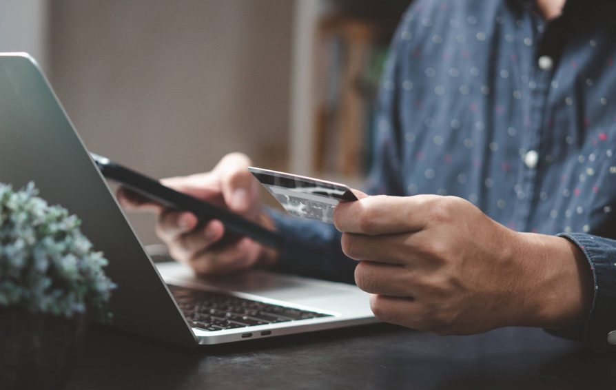 Man using an online payment portal to pay with credit card