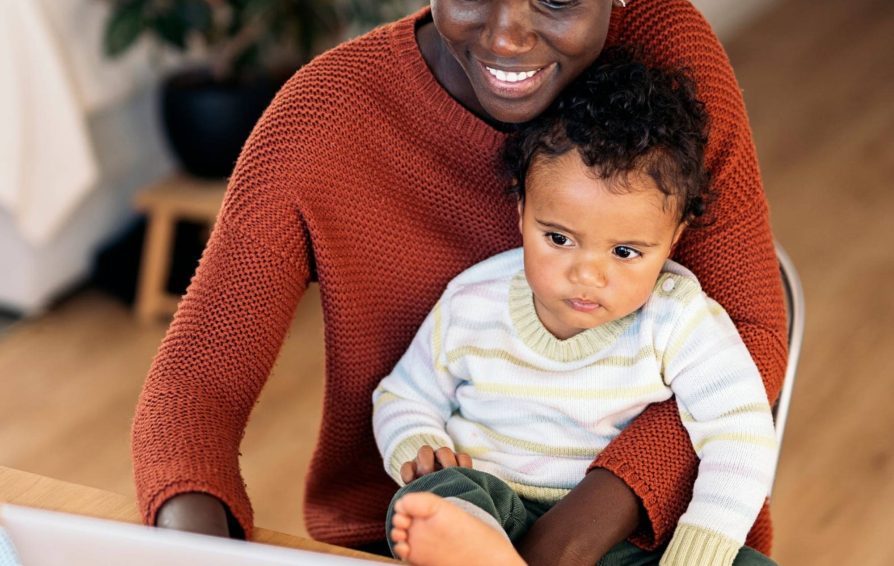 Woman holding baby before taking parental leave