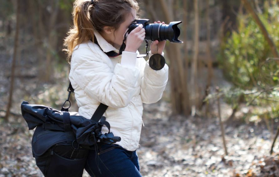 Female photographer taking photos outdoors