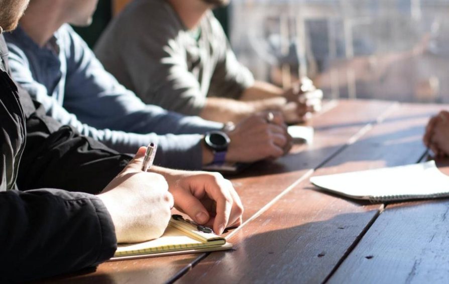 Group of people sitting around a table for a client meeting