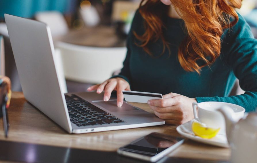 Woman entering credit card information on a laptop