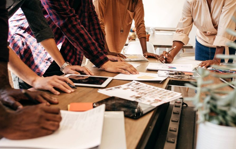 Employees working on a pricing strategy at a table