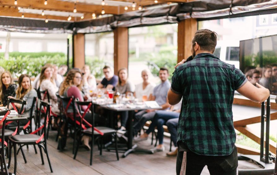 subject matter expert speaking to a group of people at a venue