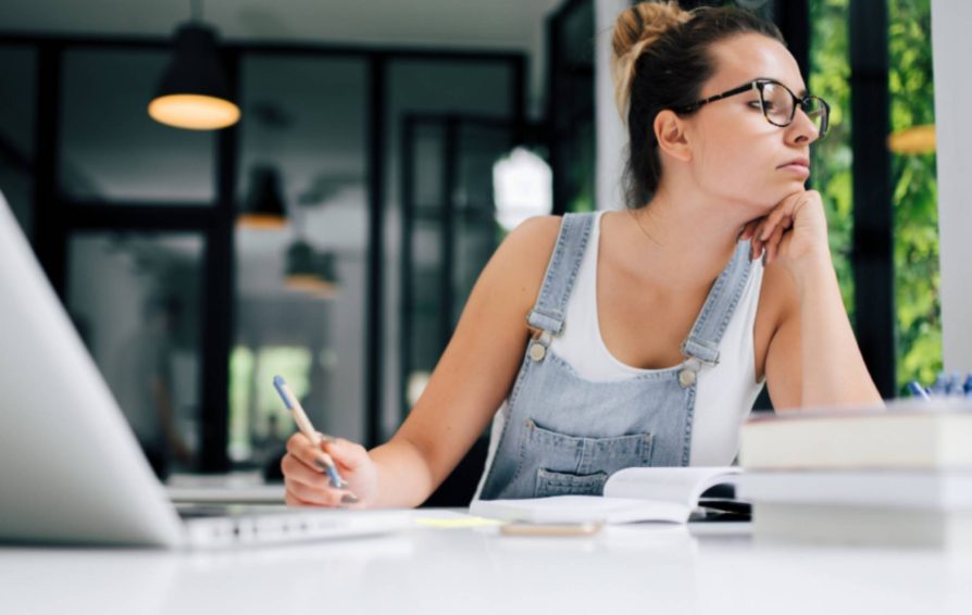 A woman procrastinating at her desk