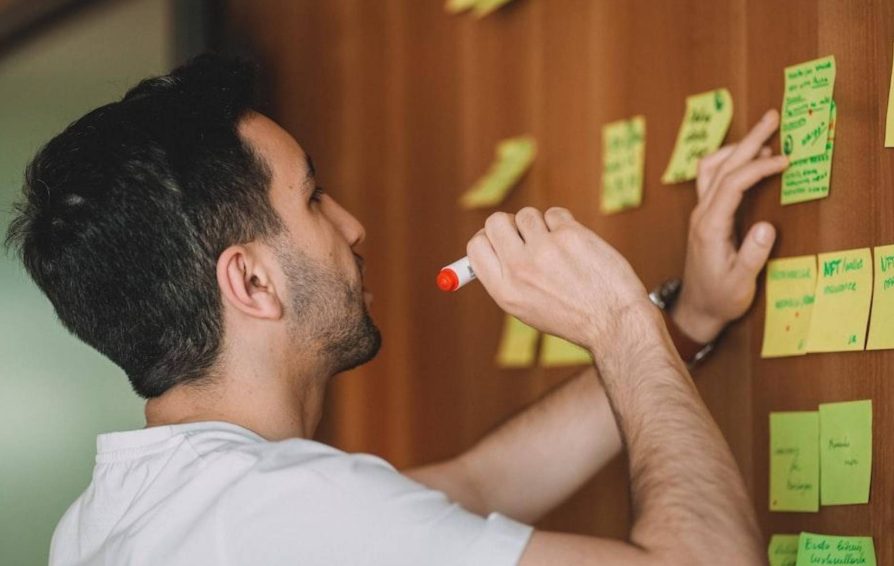 Man conducting a successful project discovery phase using sticky notes
