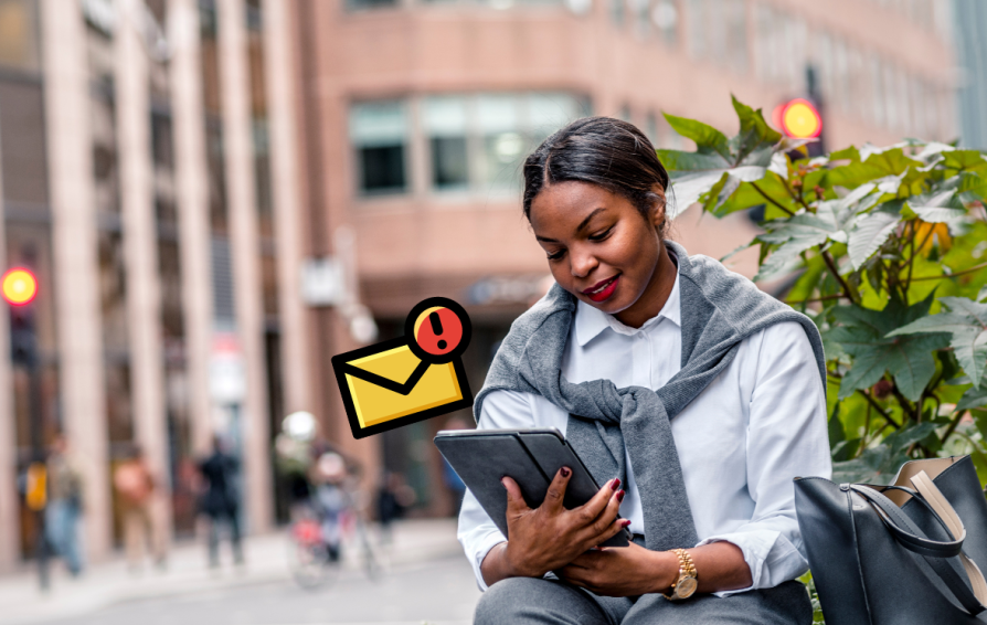 Woman looking down at an ipad with an email notification