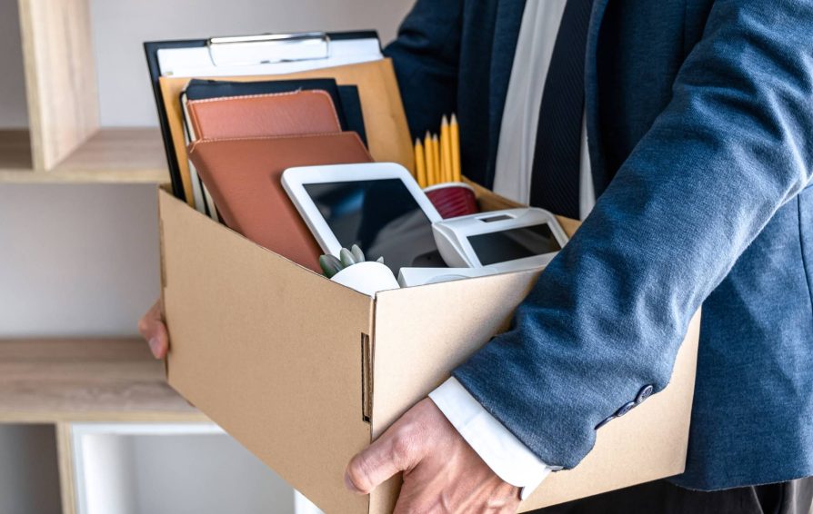 Man holding box of items after resigning