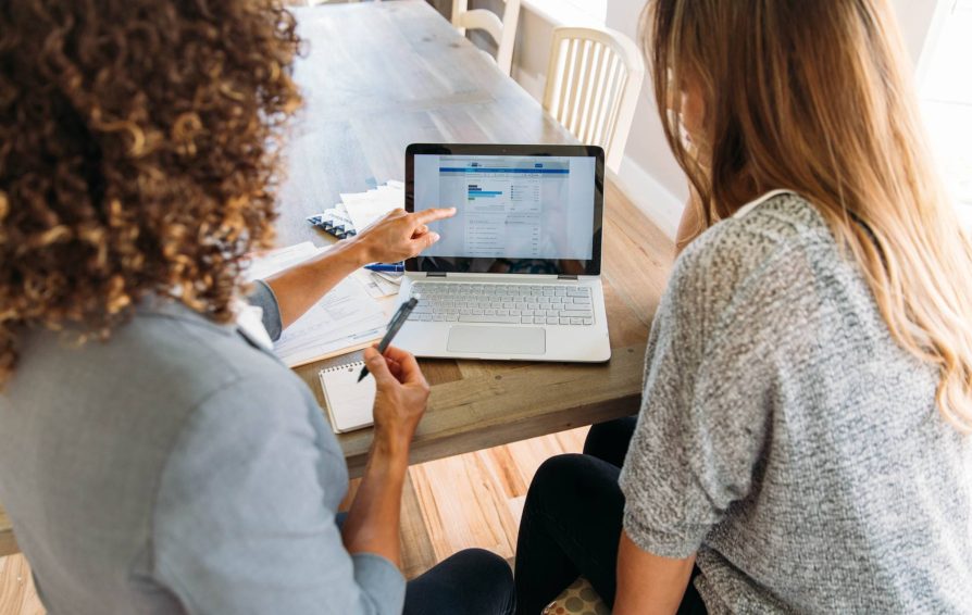 Two women looking at a computer screen