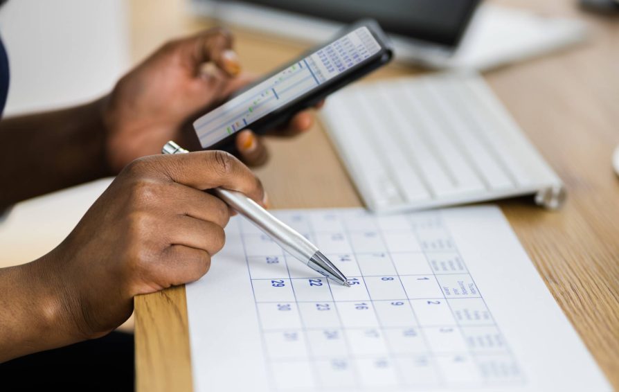 Person working on writing down a round-robin scheduling process