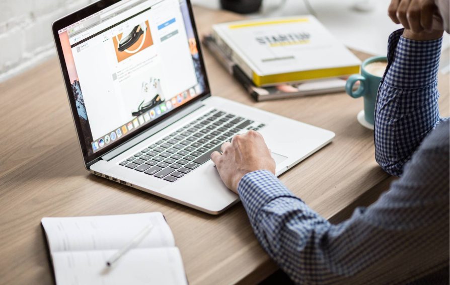 Man at computer reviewing sales tools for business