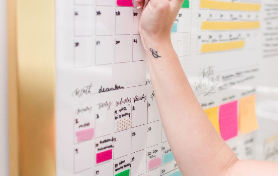 person implementing a management system with a calendar