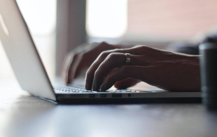 Person typing on laptop