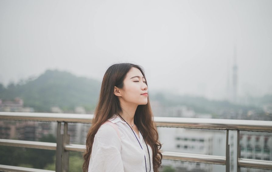 entrepreneur managing anxiety by being outside, breathing peacefully