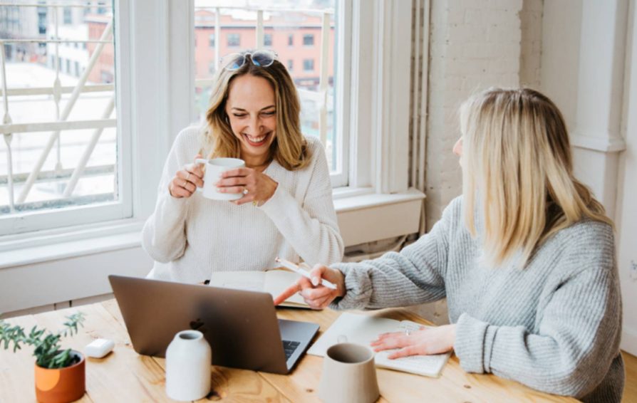 Two women chatting after setting boundaries between business and client