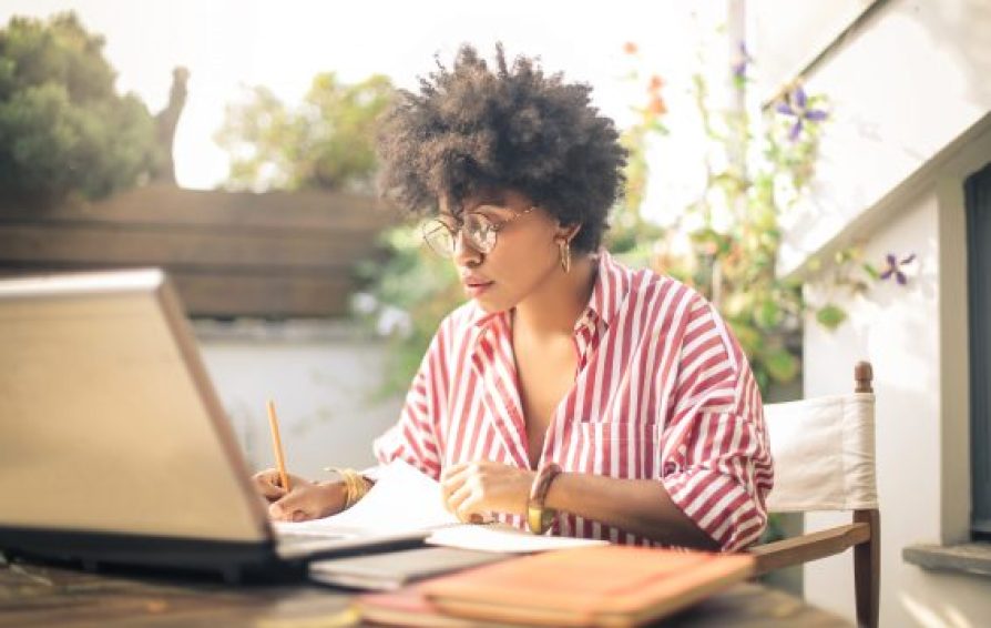 woman at a laptop learning how to attract her dream clients